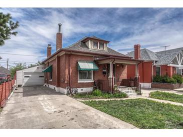 Charming brick home with a well-maintained lawn, driveway, and detached garage at 2421 W 38Th Ave, Denver, CO 80211