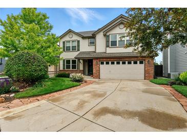 Charming two-story home featuring a brick-accented garage and a well-manicured front yard at 3151 E 134Th Cir, Thornton, CO 80241