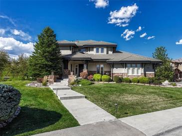 Two-story house with stone accents and landscaping at 9562 Silent Hills Ln, Lone Tree, CO 80124