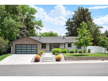 Charming single-story home with well-maintained landscaping, modern garage door, and inviting curb appeal at 2998 S Adams St, Denver, CO 80210