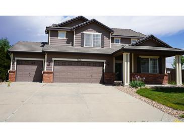 Charming two-story home with a three car garage and a well-manicured front lawn at 9616 Nucla St, Commerce City, CO 80022