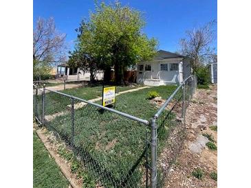 Charming single-story home with a fenced yard and mature tree at 1368 Joliet St, Aurora, CO 80010