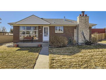 Charming brick home featuring a unique stone chimney and a cozy front bench at 2220 W 73Rd Pl, Denver, CO 80221