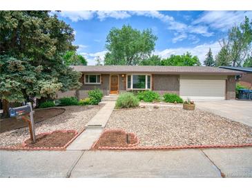 Charming brick ranch home with a manicured front yard and inviting entrance at 1607 Ulysses St, Golden, CO 80401
