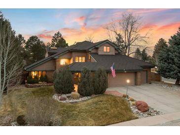 Stunning exterior view of a home showcasing its unique architecture and lush landscaping at sunset at 5034 E Otero Cir, Centennial, CO 80122