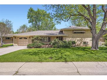 Charming single Gathering home with a brick facade, well-maintained lawn, and mature trees casting shadows at 4490 Balsam St, Wheat Ridge, CO 80033