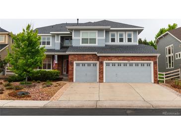Charming two-story home with a brick facade and a two-car garage showcasing curb appeal at 3902 Eagle Tail Ln, Castle Rock, CO 80104