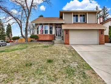 Charming two-story home with a two-car garage and a well-manicured front yard at 3973 S Joplin Way, Aurora, CO 80013