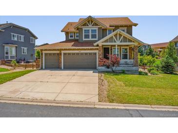 Charming two-story home with a three-car garage and well-maintained front lawn at 42350 Forest Oaks Dr, Elizabeth, CO 80107