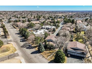 An aerial view of a residential neighborhood shows mature trees and multi-Gathering homes at 15157 E Louisiana Dr # A, Aurora, CO 80012