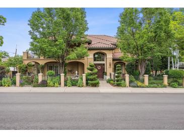 Inviting two-story home with beautiful landscaping, mature trees, and a clay tile roof at 5335 E 2Nd Ave, Denver, CO 80220