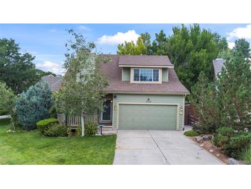 Green two-story house with attached garage and landscaped yard at 19229 E Legend Ave, Parker, CO 80134
