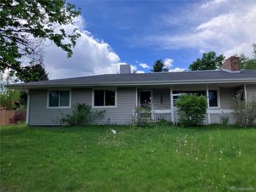 Charming one-story home with a well-maintained lawn and mature trees in a residential neighborhood at 3910 E Orchard Rd, Centennial, CO 80121