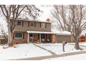 Two-story house with brick and siding exterior, covered porch, and attached garage at 360 S 30Th Ave, Brighton, CO 80601