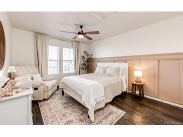 Cozy bedroom with a ceiling fan, neutral colors, and a comfortable chair at 1786 Quartz St, Castle Rock, CO 80109