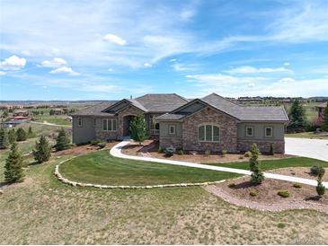 Stunning home with beautiful stone accents, landscaped yard, and pristine walkway at 5195 Raintree Cir, Parker, CO 80134