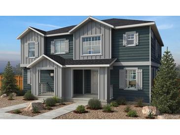 Charming two-story home with stylish shutters and manicured landscaping at 1663 Marketplace Aly, Brighton, CO 80601