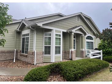 Charming single-story home with a well-maintained lawn and beautiful landscaping at 14400 Albrook Dr # 88, Denver, CO 80239