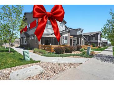 Charming townhome with a well-manicured lawn and inviting outdoor patio space, perfect for relaxation and entertaining at 12497 W Virginia Ave, Lakewood, CO 80228