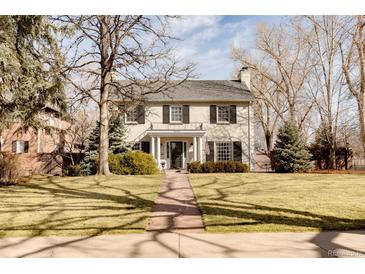 Charming two-story home with landscaped yard, symmetrical design, and classic architectural details at 5555 E 17Th Avenue Pkwy, Denver, CO 80220