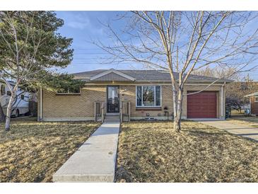 Charming brick home featuring a well-maintained front yard and an attached single-car garage at 110 E 104Th Pl, Northglenn, CO 80233