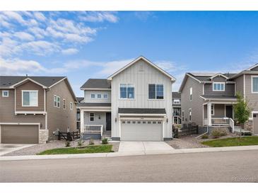 Charming two-story home with a well-manicured lawn and a two-car attached garage at 199 Simmental Loop, Castle Rock, CO 80104