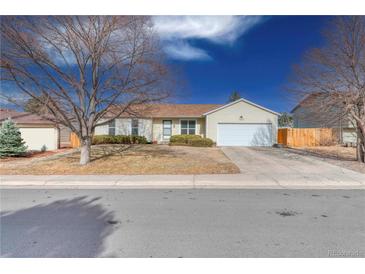 Charming single-story home with manicured lawn and attached two-car garage at 1167 S Ceylon St, Aurora, CO 80017