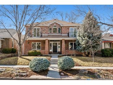 Charming two-story brick home with landscaped yard, columns, and upper-level balconies at 1215 S Ogden St, Denver, CO 80210