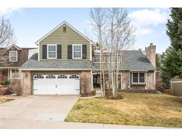 Charming two-story home with a two car garage and a beautifully landscaped front yard at 5951 E Irish Pl, Centennial, CO 80112