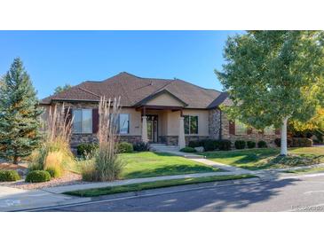Beautiful ranch home with stone accents and landscaped lawn at 449 Meadow View Pkwy, Erie, CO 80516