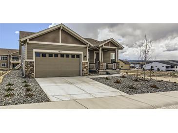 Charming single-Gathering home featuring a two-car garage and low maintenance xeriscape in front yard at 483 Agoseris Way, Castle Rock, CO 80104