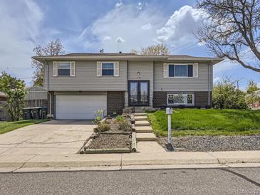 Charming two-story home featuring a well-maintained front yard, garage and inviting entrance at 1488 W 102Nd Ave, Northglenn, CO 80260
