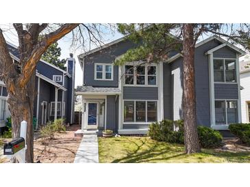 Charming two-story home with a well-maintained lawn, complemented by mature trees and inviting curb appeal at 2353 S Jamaica St, Aurora, CO 80014