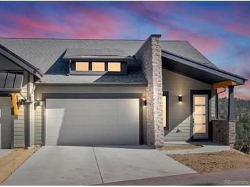 Modern mountain home exterior with attached garage and stone accents at 3897 Piney Grove St, Evergreen, CO 80439