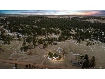 Expansive aerial view of a secluded home surrounded by natural landscape and trees at 11840 Elkhorn Dr, Franktown, CO 80116