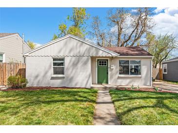 Charming single story home with a green door, pathway, and well-manicured lawn and garden at 4120 S Lincoln S St, Englewood, CO 80113