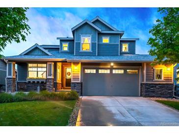 Charming two-story home with a two-car garage and well-maintained front yard and stone facade at 4738 Colorado River Dr, Firestone, CO 80504