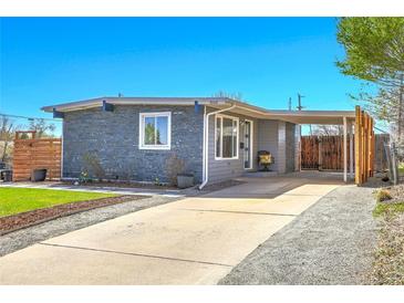 Charming single-story home with a covered parking area and well-maintained front yard at 5000 W Dakota Ave, Denver, CO 80219