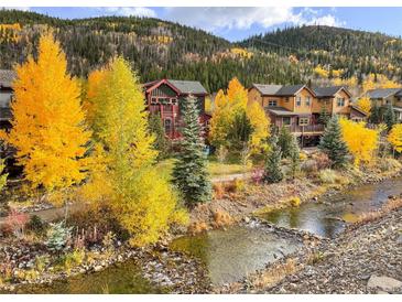 Scenic home exterior featuring a mountain stream and vibrant autumn foliage at 186 Rachel Ln, Breckenridge, CO 80424