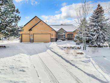 Stunning two-story home with a snow-covered front yard at 1585 Old Antlers, Monument, CO 80132