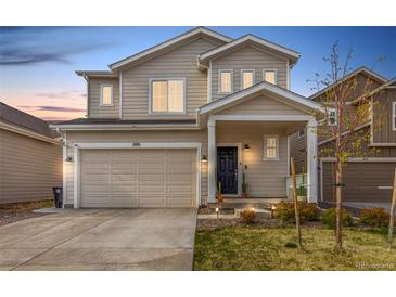 Charming two-story home with a well-maintained lawn and inviting front porch, featuring a two car garage at 509 High Point Dr, Longmont, CO 80504
