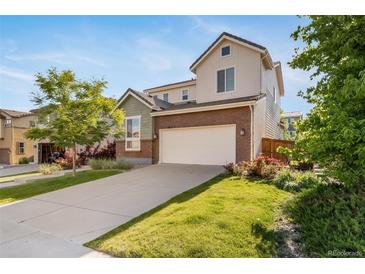 Two-story home with a two-car garage, driveway, landscaped yard and beautiful curb appeal at 14035 Touchstone St, Parker, CO 80134