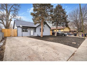 Updated bungalow home exterior, landscaped yard, and driveway at 655 S Osceola St, Denver, CO 80219