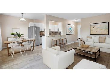 Open-concept living room and kitchen area with stainless steel appliances and counter seating at 1350 Josephine St # 502, Denver, CO 80206
