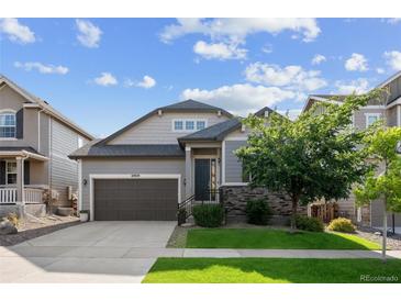 Beautiful two-story home with a well-maintained lawn, charming stone accents, and a two-car garage at 10929 Endeavor Dr, Parker, CO 80134