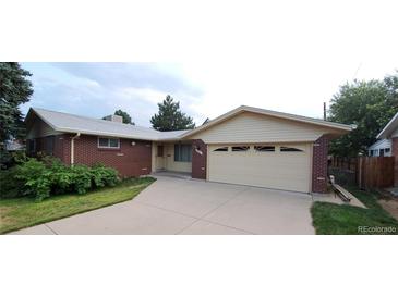Charming brick home with a two-car garage and well-maintained front yard and long driveway at 8947 Rutgers St, Westminster, CO 80031