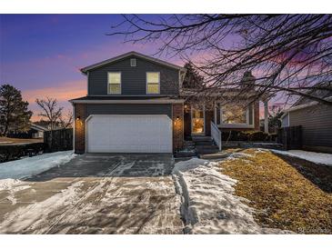 Two-story house with attached garage and landscaped yard at 8546 Willows Pl, Parker, CO 80134