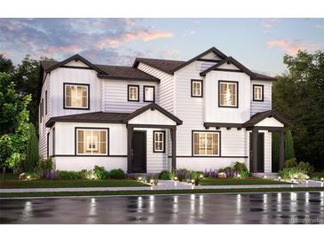 Striking new construction two-story home featuring black trimmed windows and a manicured front lawn at 14145 Deertrack Ln, Parker, CO 80134