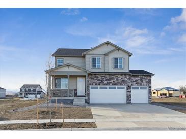 Charming two-story home with a three-car garage, stone accents and covered porch at 4204 Sandstone Dr, Mead, CO 80504