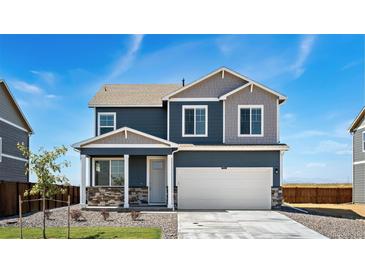 Charming two-story home featuring a two car garage and a well-maintained front yard with beautiful blue siding at 4204 Sandstone Dr, Mead, CO 80504